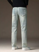 Men’s light-wash denim jeans with a straight fit and classic back pockets shown from the back side
