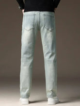 Men’s wash straight fit light-wash denim jeans with straight leg cut and classic back pockets shown from the back side