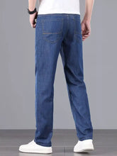 Men’s wash straight leg comfort jeans in blue denim showing the back side with visible stitching on back pockets