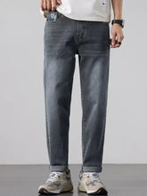 Men’s dark-wash straight leg jeans with rolled cuffs made from durable denim fabric for everyday wear