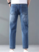Men’s wash straight leg jeans in blue denim shown from the back with classic back pockets and straight-leg cut