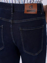 Dark blue denim men’s wash straight-leg jeans with a brown leather patch featuring semus & soda logo on back side