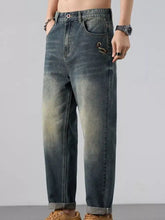 Men’s wash straight leg jeans in dark-wash denim with a faded, distressed look and rolled cuffs