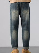 Men’s wash straight leg jeans in dark-wash denim with a faded distressed look and rolled cuffs