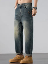 Men’s wash straight leg jeans in dark-wash denim with a faded gradient and embroidered snake on the front pocket