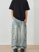 Men’s light-wash denim cargo jeans with multiple large pockets and relaxed wide leg cargo fit