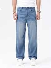 Men’s light-wash blue denim wide leg jeans with a relaxed fit made from durable cotton fabric
