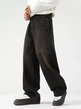 Men’s black wide leg jeans in denim with a faded distressed finish and classic stitching details