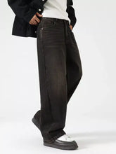 Men’s wash wide leg jeans in black denim with faded distressed finish and classic five-pocket design