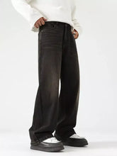 Men’s black wide leg jeans in denim with a faded distressed finish and classic five-pocket design