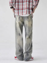 Men’s distressed gray denim wash wide-leg jeans featuring a faded watercolor-like wash with subtle white speckles