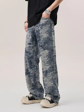 Men’s wash wide leg jeans in faded blue and gray distressed camouflage pattern with wide-leg denim design