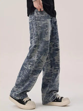 Men’s wash wide leg denim jeans with faded distressed camouflage pattern in blue and gray shades
