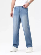 Mens wash wide leg jeans in light-wash blue denim with a relaxed straight-leg cut for casual wear