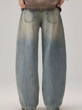 Men’s light-wash denim wide leg jeans with a relaxed fit and subtle fading for a vintage look