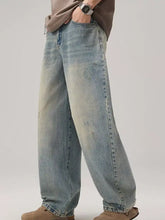 Men’s light-wash denim wide leg jeans with a relaxed fit and subtle distressed details in a wide leg style
