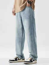 Men’s wash wide leg jeans in light-wash denim with slight stretch and subtle distressed details for a relaxed fit