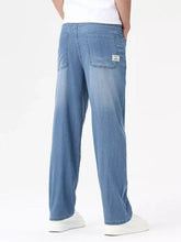 Men’s wash wide leg jeans in light-wash denim with a relaxed straight-leg cut and subtle fading for a modern casual look