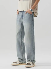 Men’s wash wide leg jeans in light-wash denim with a relaxed straight-leg cut and visible stitching details