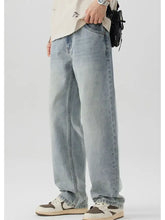 Men’s wash wide leg jeans in light wash denim with relaxed straight-leg cut and visible stitching details