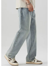 Men’s wash wide leg jeans in light-wash denim with a relaxed straight-leg cut and visible stitching along the seams