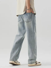Men’s wash wide leg jeans in light-wash denim with a relaxed straight-leg cut and classic stitching details