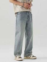 Men’s wash wide leg jeans in light-wash denim with a relaxed straight-leg cut and subtle fading for a modern casual look