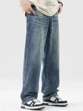 Men’s wash wide leg jeans in medium-wash denim with subtle fading and distressing details on wide leg jeans design