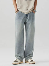 Men’s wash wide leg jeans in light-wash denim with a relaxed straight-leg cut and visible stitching details