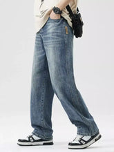 Mens light-wash blue denim wide leg jeans with relaxed straight-leg cut and subtle fading details