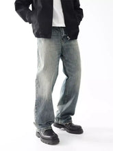 Men’s wash wide leg relaxed fit jeans in faded blue denim with frayed hems and a relaxed silhouette