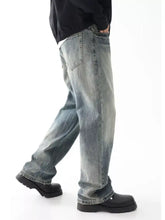 Men’s light-wash denim jeans with wide leg relaxed fit and frayed hems in a straight-leg cut