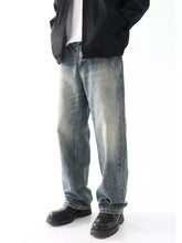 Men’s washed blue denim jeans with a relaxed wide leg fit and subtle fading in a straight-leg cut