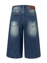 Mens washed denim Bermuda shorts with faded wash and brown leather patch