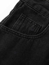 Close-up of mens washed denim Bermuda shorts pocket with stitching