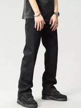 Men’s black straight-leg washed loose fit jeans with faded wash and visible stitching details in denim material