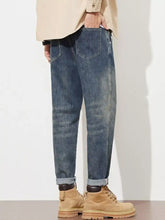 Men’s washed loose fit jeans in dark-wash denim with a relaxed fit and rolled cuffs for casual wear