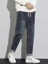 Men’s dark-wash denim cuffed jeans with a relaxed fit and washed relaxed fit designed for comfort and style