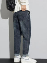 Dark blue denim men’s washed relaxed fit cuffed jeans with a relaxed fit and rolled cuffs for casual wear
