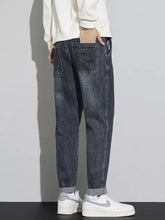 Men’s dark-wash denim cuffed jeans with a washed relaxed fit and relaxed fit for comfortable wear