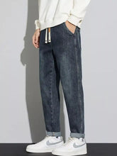 Men’s dark-wash denim cuffed jeans with a washed relaxed fit and comfortable rolled cuffs for casual wear