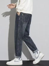 Men’s dark-wash denim cuffed jeans with a relaxed fit featuring rolled cuffs and washed relaxed fit styling