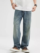 Men’s washed relaxed fit blue denim jeans with a faded distressed look and straight-leg cut