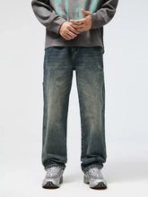 Men’s dark-wash denim relaxed fit jeans with a faded, distressed look and subtle fading along the legs