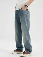 Men’s washed relaxed fit blue denim jeans with a straight-leg cut and subtle fading for a casual vintage look