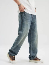 Men’s washed relaxed fit jeans in light-wash denim with a relaxed straight-leg cut and subtle fading for a casual look