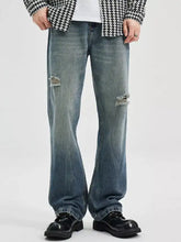 Men’s washed ripped bootcut jeans in distressed blue denim with flare legs and ripped knee details