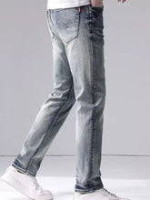 Men’s washed slim fit jeans in light-wash denim with subtle fading and red brand tag on the back waistband