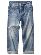 Men’s washed straight jeans in light-wash denim with a faded distressed look and rolled cuffs