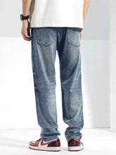 Men’s washed straight jeans in light-wash denim with a relaxed straight-leg cut and subtle fading for a casual look